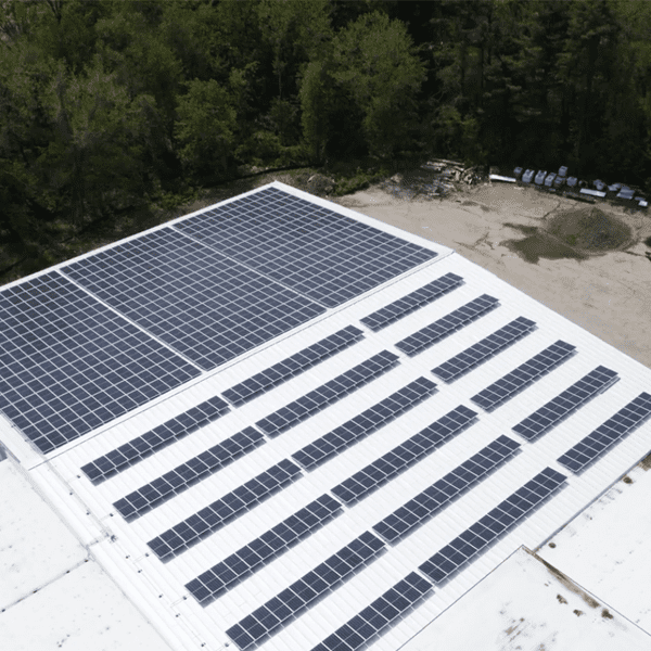 Solar panels on the roof of a large warehouse.