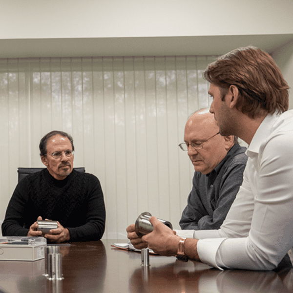 A group of men sitting around a conference table.