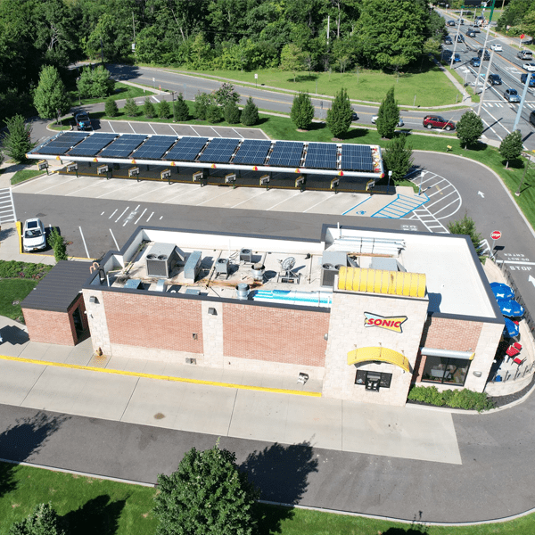 Aerial view of a Sonic restaurant with solar panels on the roof.