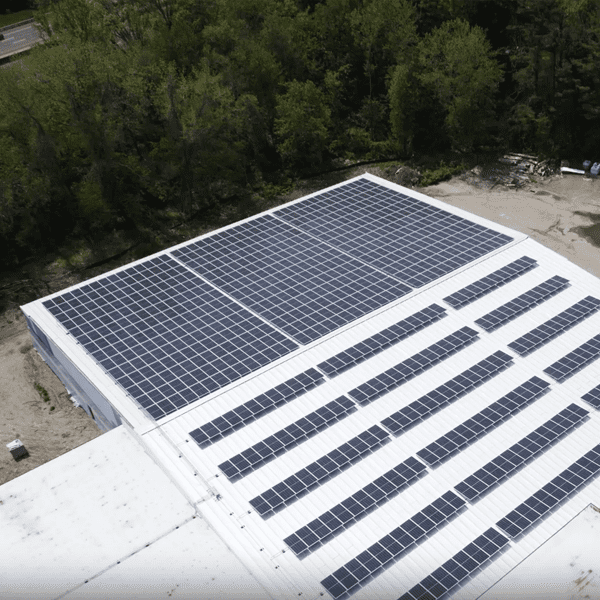 Solar panels on the roof of a large warehouse.