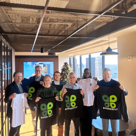 Budderfly board members holding up black Budderfly shirts.