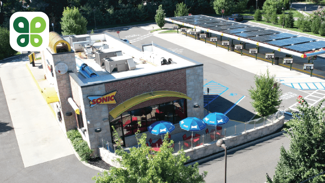 Aerial view of a Sonic restaurant with solar panels on the roof.
