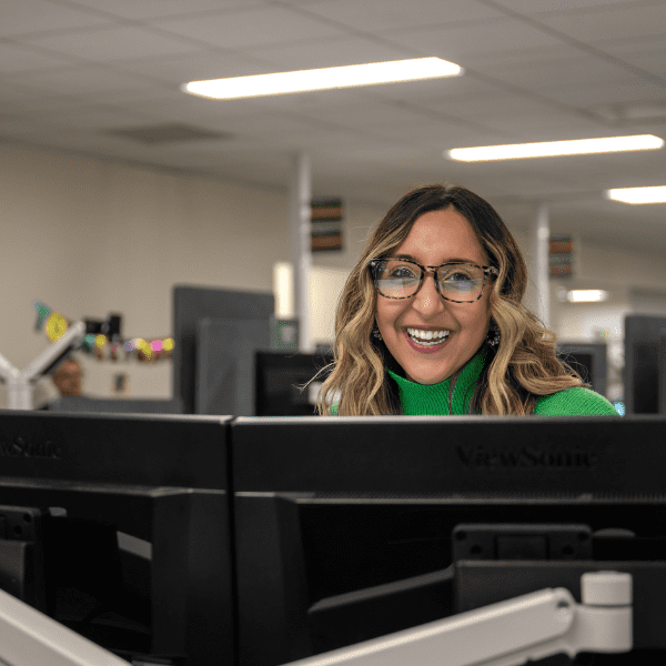 Woman smiling at her office desk.